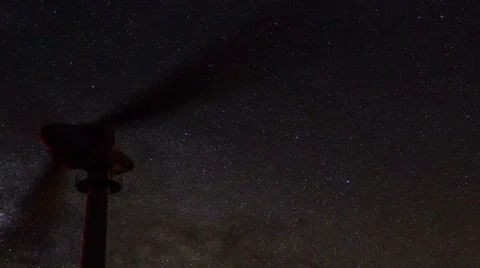 Wind turbines generating clean power with milky way Stock Footage 33802067