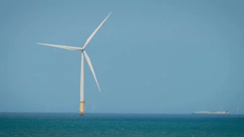 Wind turbines generating clean renewable electricity offshore in open sea Stock Footage 313265722