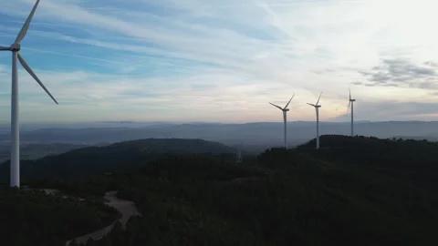 Wind turbines generating clean renewable energy at sunset Stock Footage 327125980
