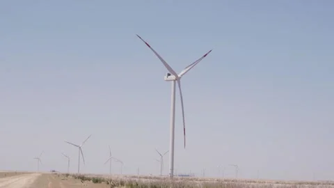Wind turbines generating electricity in open field Video stock 347379662