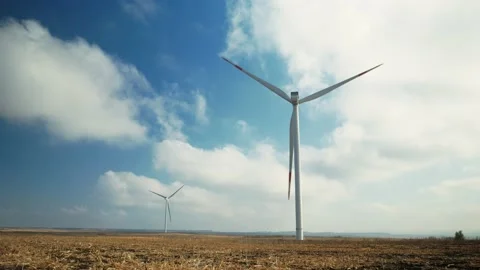Wind turbines generating power, farm on the field in sunny day Stock Footage 147455251