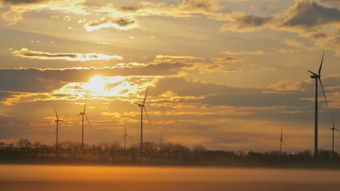 Wind turbines generating renewable energy, morning beautiful sunrise light Stock Footage 127197865