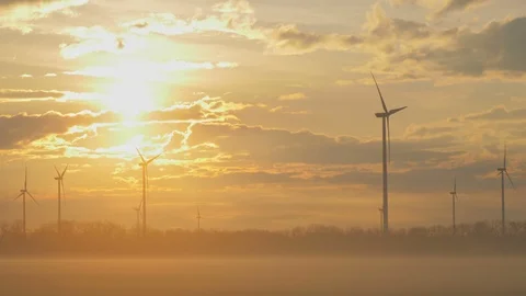 Wind turbines generating renewable energy, morning beautiful sunrise light Stock Footage 127198149