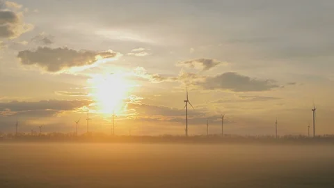 Wind turbines generating renewable energy, morning beautiful sunrise light Stock Footage 127198210
