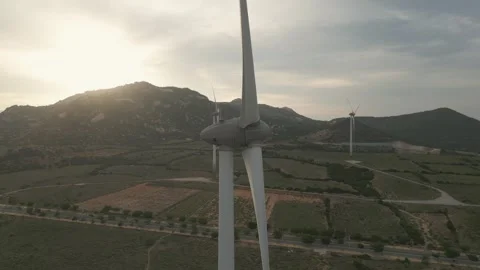 Wind turbines generating renewable energy at sunset in scenic landscape Stock Footage 309426056