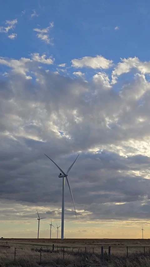 Wind turbines generating renewable energy at sunset. 4K Stock Footage 330341432
