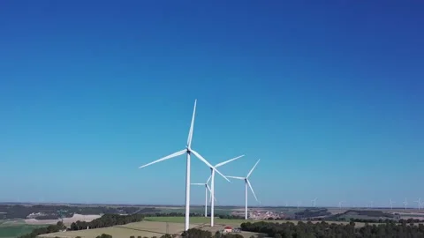 Wind Turbines Generating Renewable Energy Under Blue Sky with Large Copy Space Stock Footage 330945542