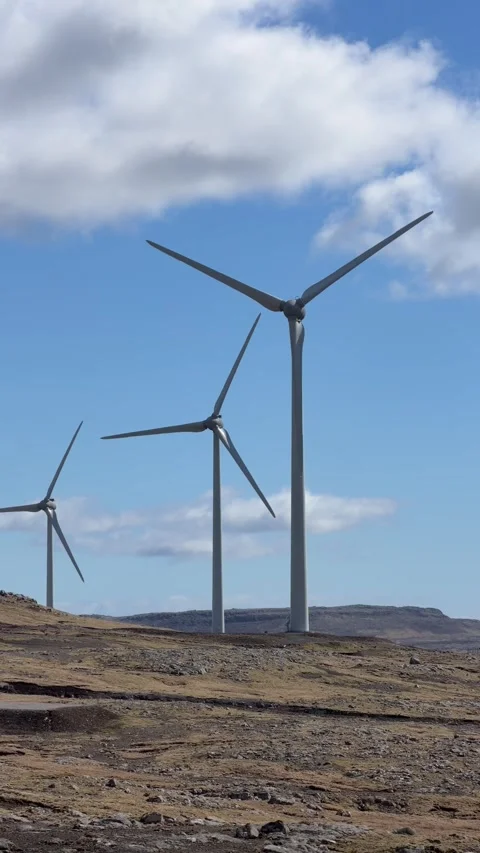 Wind turbines generating renewable energy on a green hillside in the Faroe Islan Stock Footage 335269456