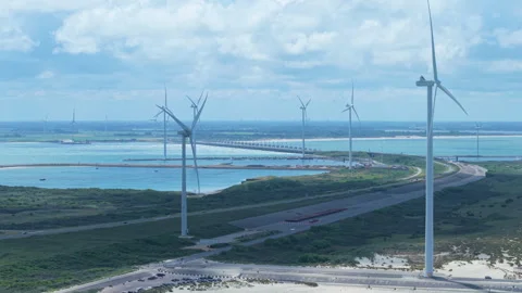 Wind turbines generating renewable energy at the Oosterscheldekering storm 動画素材 338127664