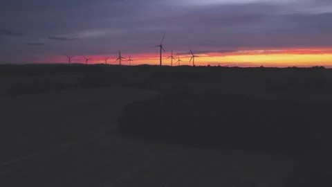 Wind Turbines Generating Renewable Energy at Sunset Over Rural Landscape Video stock 345110387