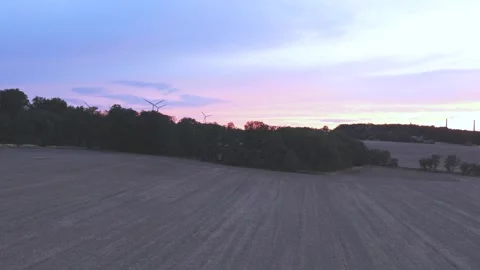 Wind Turbines Generating Renewable Energy at Sunset Over Rural Landscape Stock Footage 345110658