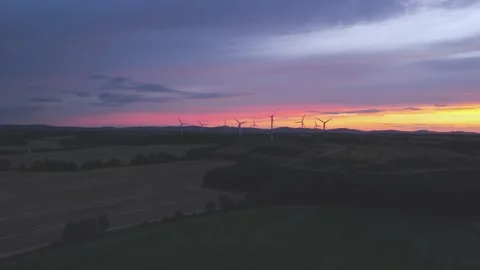 Wind Turbines Generating Renewable Energy at Sunset Over Rural Landscape Stock Footage 345110880