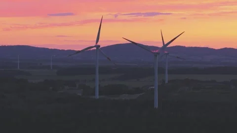 Wind Turbines Generating Renewable Energy at Sunset Over Rural Landscape Stock Footage 345111255