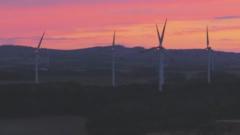 Wind Turbines Generating Renewable Energy at Sunset Over Rural Landscape Stock Footage 345111365