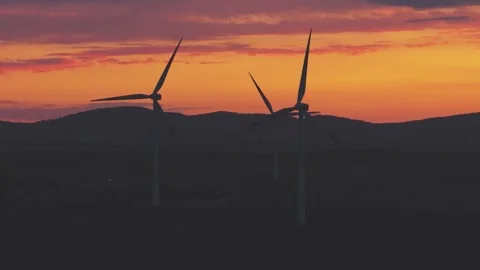 Wind Turbines Generating Renewable Energy at Sunset Over Rural Landscape Stock Footage 345111715