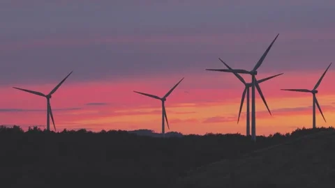 Wind Turbines Generating Renewable Energy at Sunset Over Rural Landscape Stock Footage 345111828