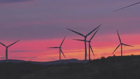 Wind Turbines Generating Renewable Energy at Sunset Over Rural Landscape Stock Footage 345111992