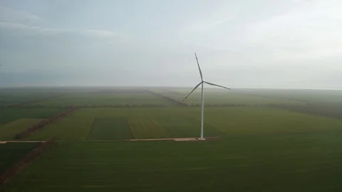 Wind turbines on a green field Stock Footage 129977044