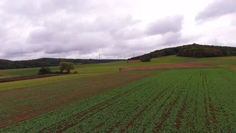Wind Turbines in a Green Field Stock Footage 290970412