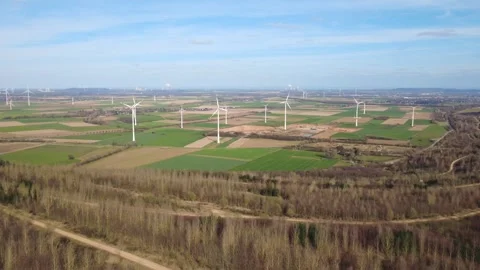 Wind Turbines on Green Fields with Winter Forest Landscape Stock Footage 330947504