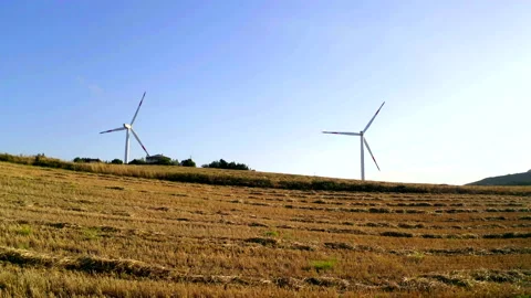 Wind turbines for harvesting fields and generating electricity Stock Footage 138735052