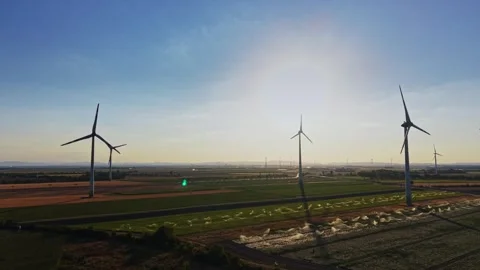 Wind turbines in a large field during sunset Video stock 342608598