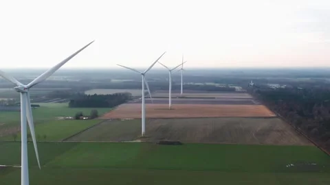 Wind turbines in line in a meadow on a cloudy morning Stock Footage 240388238