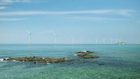 Wind turbines lined up over the sea. Sea and sky scenery. Jeju island. Stock Footage 136645227