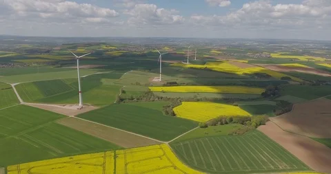 Wind Turbines in the Middle of Rapeseed Field Stock Footage 90793352