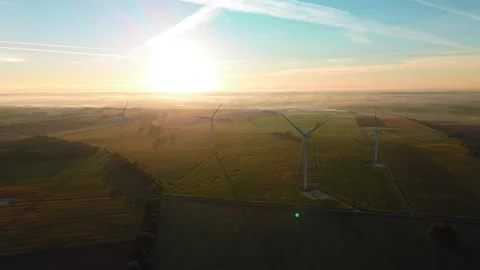 Wind Turbines in Misty Fields at Sunrise, Aerial View Stock Footage 336961804