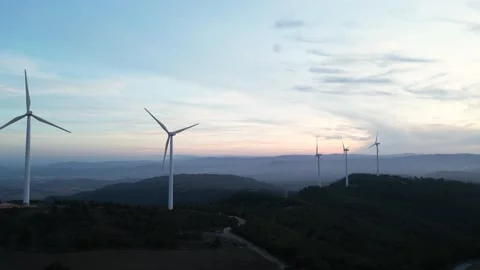 Wind turbines in motion with mountain scenery from above Stock Footage 327275587