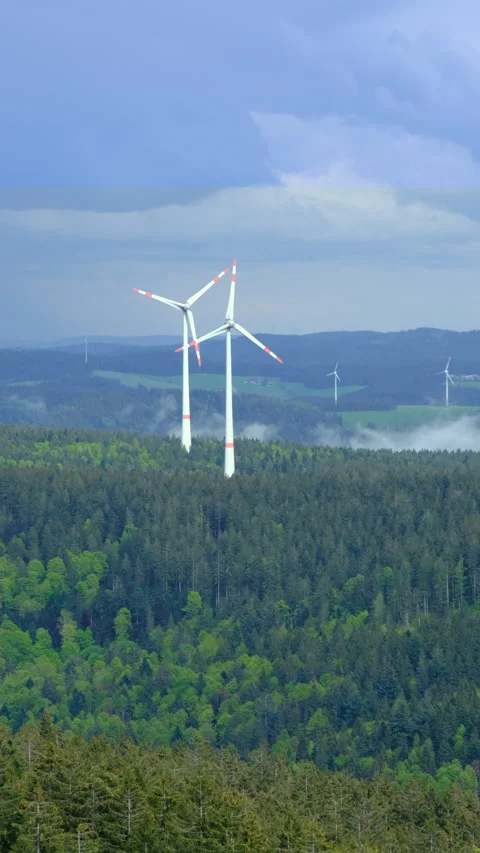 Wind turbines on the mountain in the low clouds and fog Stock Footage 278100573