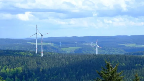 Wind turbines on the mountain in the low clouds and fog Stock Footage 278155942