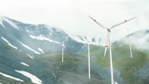 Wind turbines on a mountain pass, renewable energy. Clouds are floating, a hazy  Stock Footage 221612117
