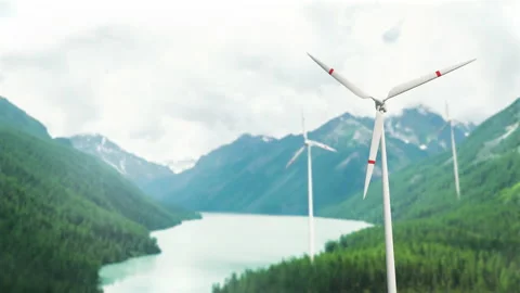 Wind turbines on a mountain pass, renewable energy. Clouds are floating, a hazy  Video stock 225067552