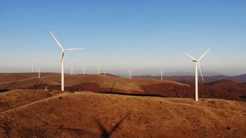 Wind Turbines In Mountain Rotating Generating Electricity At Sunset, Drone Shot Video stock 126732934