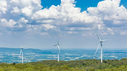 Wind turbines on mountain under cloud and blue sky background Stock Footage 179370168