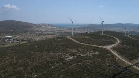 Wind turbines with moving rotating blades in wind energy field with bright blue Stock-Footage 201415296
