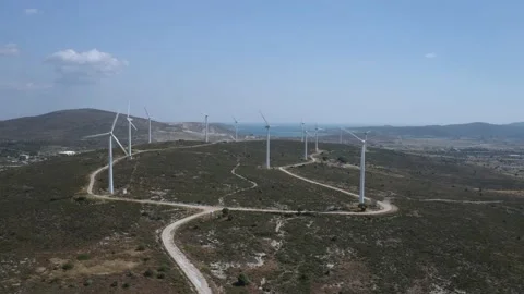 Wind turbines with moving rotating blades in wind energy field with bright blue Stock-Footage 201415548
