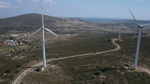 Wind turbines with moving rotating blades in wind energy field with bright blue Stock-Footage 201416549