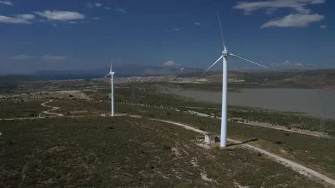 Wind turbines with moving rotating blades in wind energy field with bright blue Stock-Footage 201418549