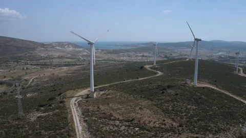 Wind turbines with moving rotating blades in wind energy field with bright blue Stock-Footage 201423506
