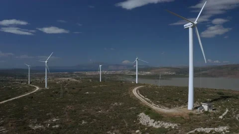 Wind turbines with moving rotating blades in wind energy field with bright blue Stock-Footage 201425560