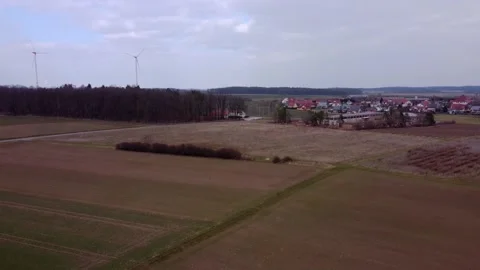 Wind turbines near fields and villages Stock Footage 174281710