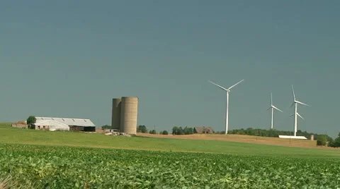 Wind turbines over an agricultural field Stock Footage