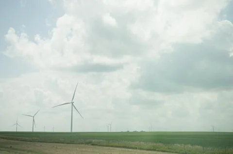 Wind turbines over flat green fields in Illinois with copy space Stock Photos