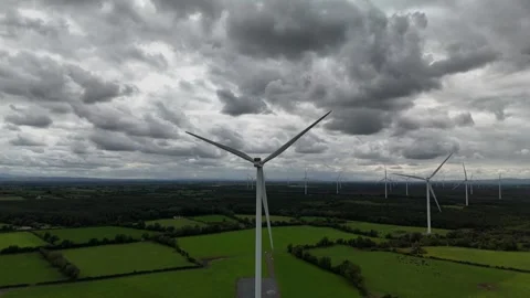 Wind Turbines Over Green Fields Under Dramatic Cloudy Sky Stockbeeldmateriaal 333413282