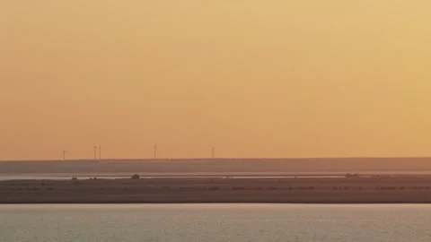 Wind turbines over the lake Stock Footage 243528779