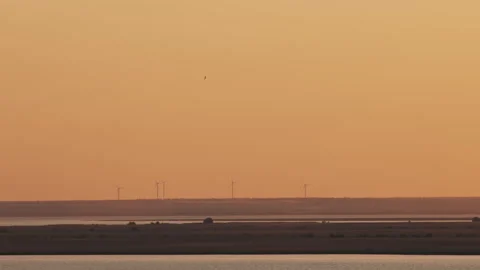 Wind turbines over the lake Stock Footage 243841695