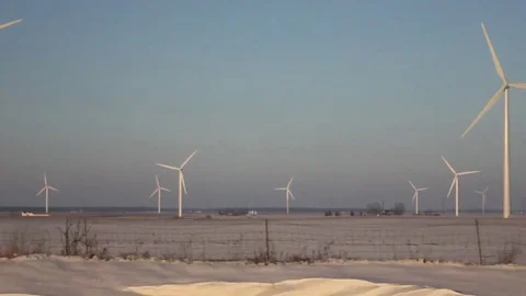 Wind Turbines PAN ACROSS Field - Old Timey-Looking Footage Stock Footage 77326257